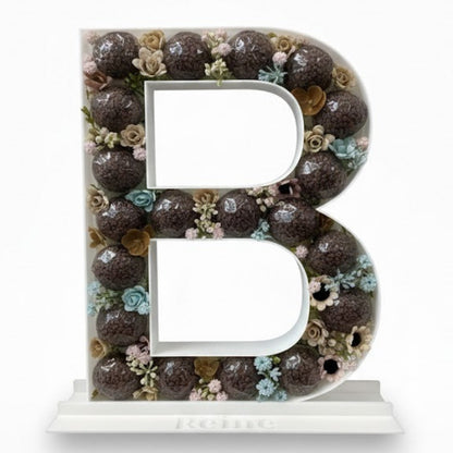 Decorative letter 'B' with floral pattern 