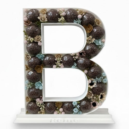 Decorative letter 'B' with floral pattern 