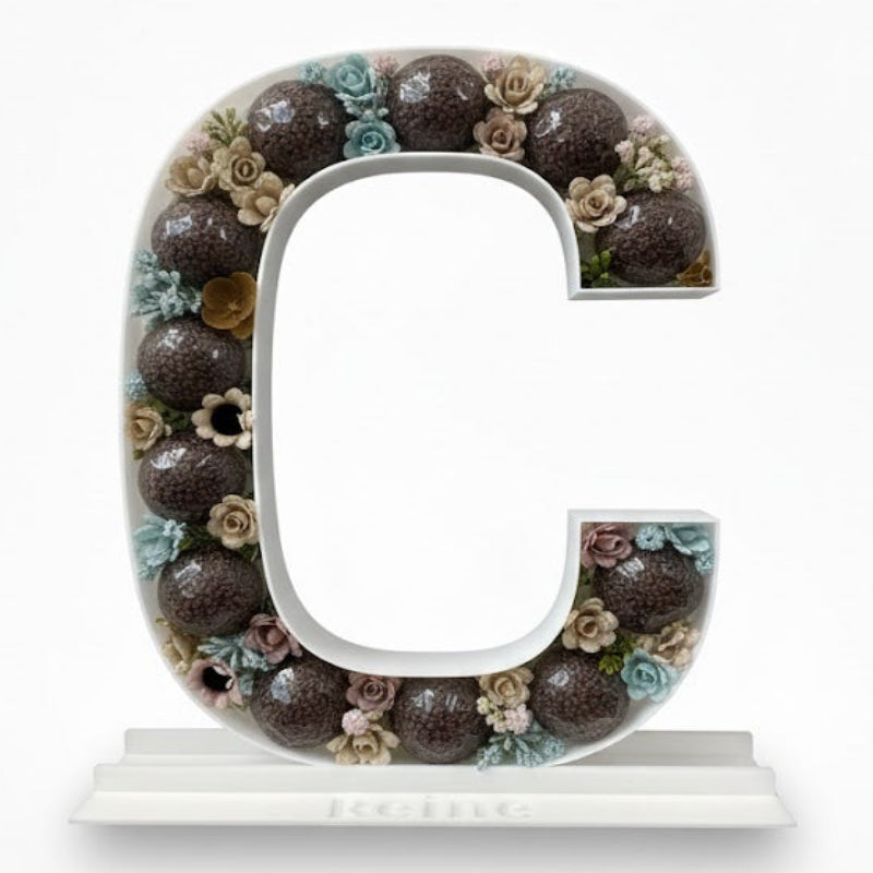 Decorative letter 'C' with floral design 
