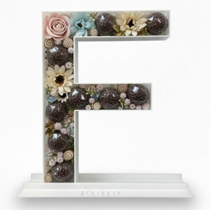 Decorative letter 'E' made of flowers 