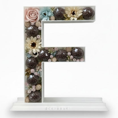 Decorative letter 'E' made of flowers 