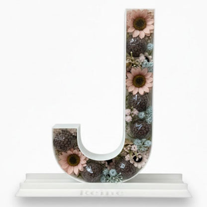 Decorative letter 'J' with floral design 