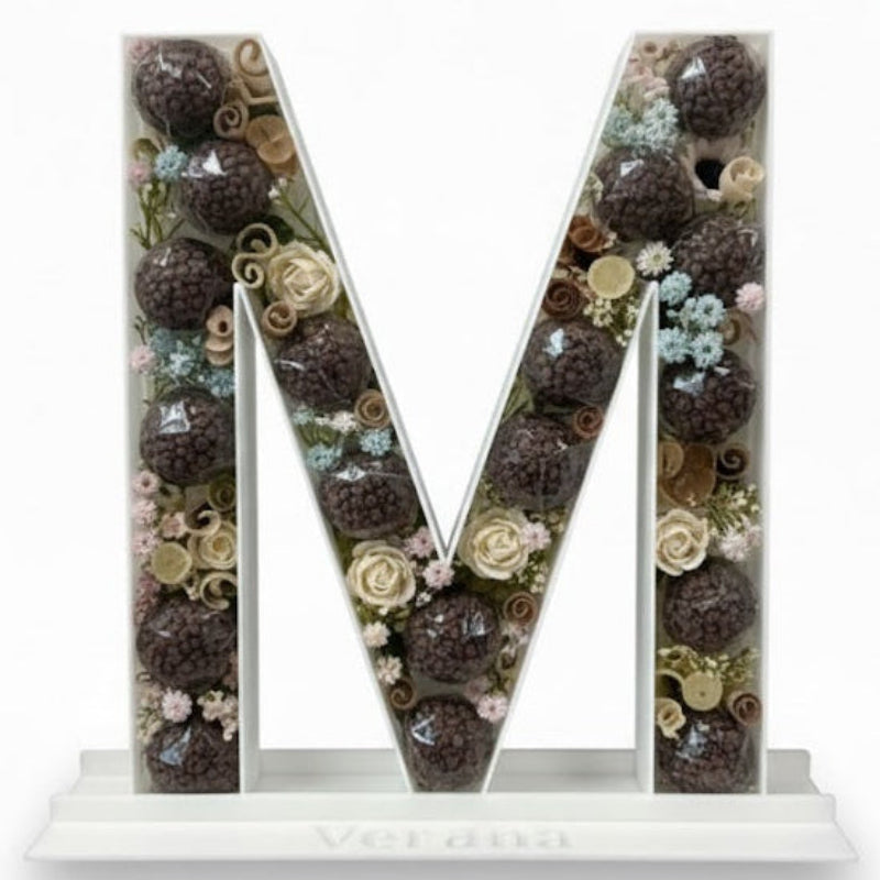 Decorative letter 'M' with floral 