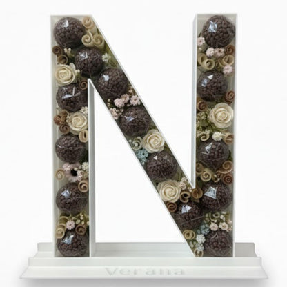 Decorative letter 'N' with a floral pattern 