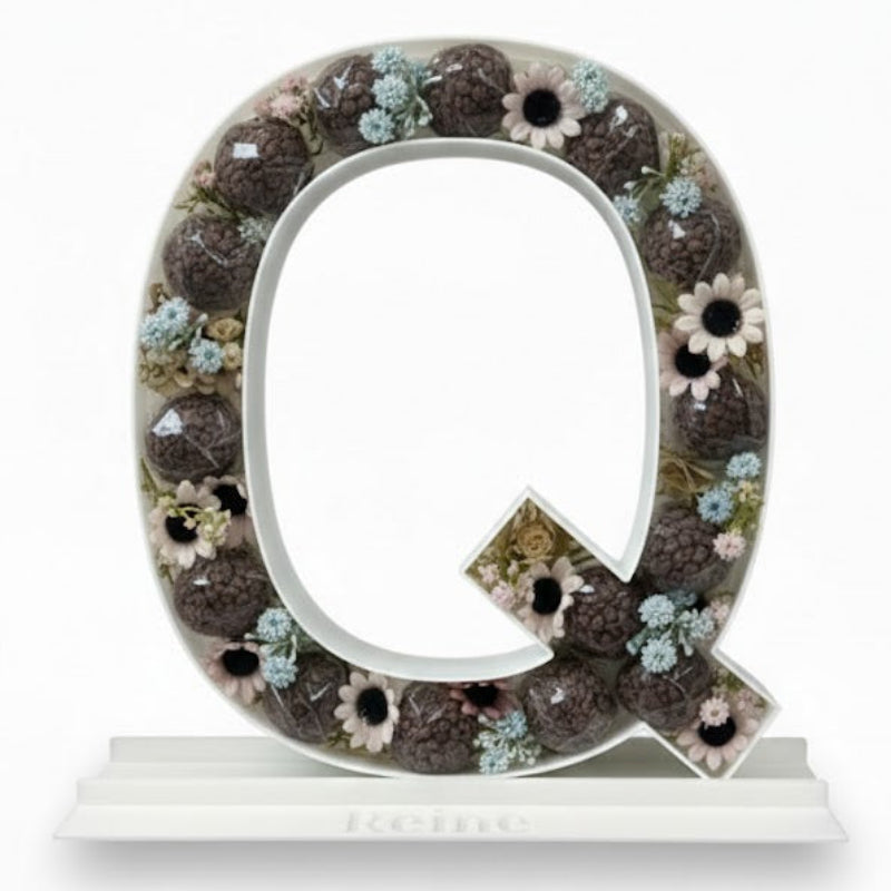 Decorative letter 'Q' with floral design 