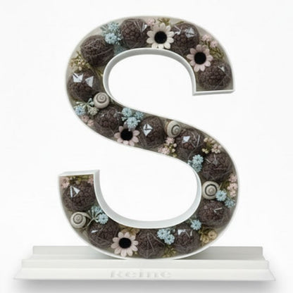Decorative letter 'S' with a floral pattern 