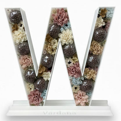 Decorative letter 'W' with floral design 