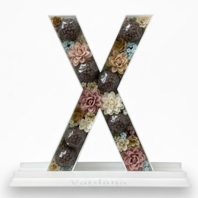 Decorative letter 'X' with floral pattern 